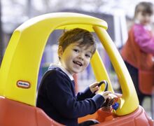 Reception boy in red and yellow car