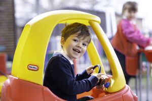 Reception boy in red and yellow car